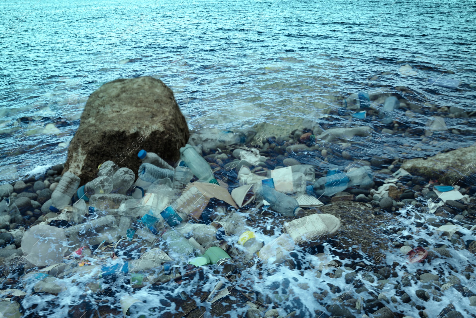 Image of Environmental pollution. Sea beach with plastic garbage