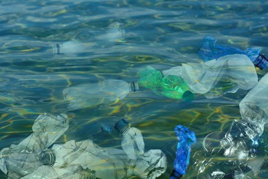 Image of Environmental pollution. Ocean water with plastic garbage