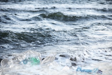 Image of Environmental pollution. Sea beach with plastic garbage