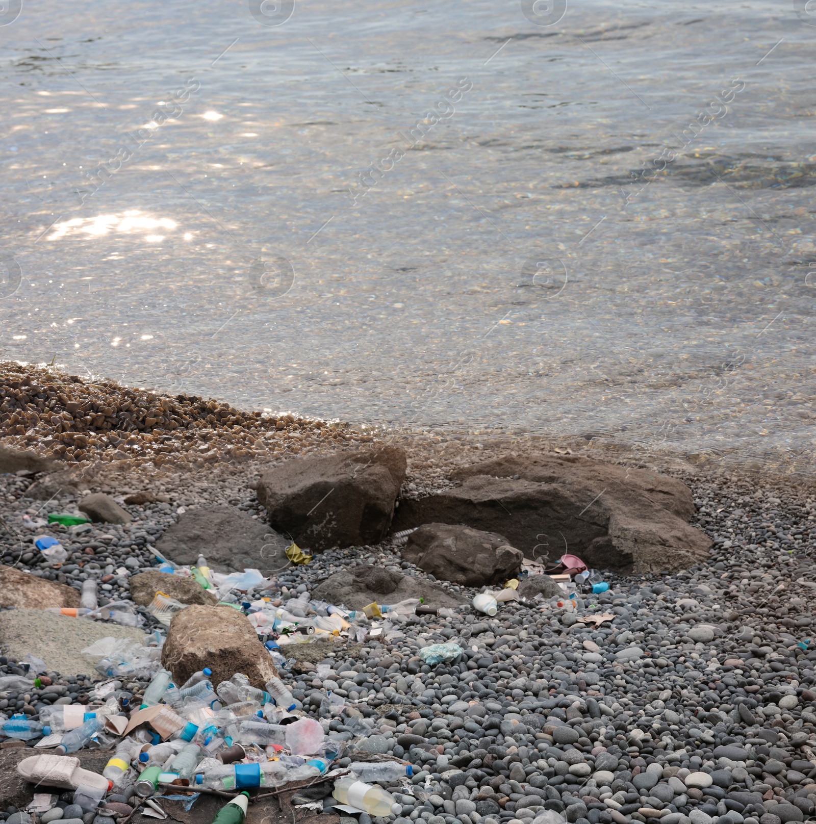 Image of Environmental pollution. Sea beach with plastic garbage