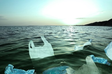 Image of Environmental pollution. Sea water with plastic garbage