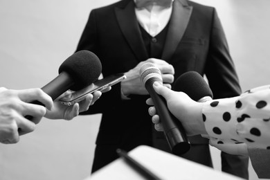 Image of Journalists interviewing celebrity, closeup. Toned in black-and-white