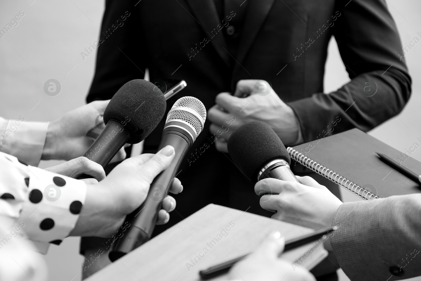 Image of Journalists interviewing businessman, closeup. Toned in black-and-white