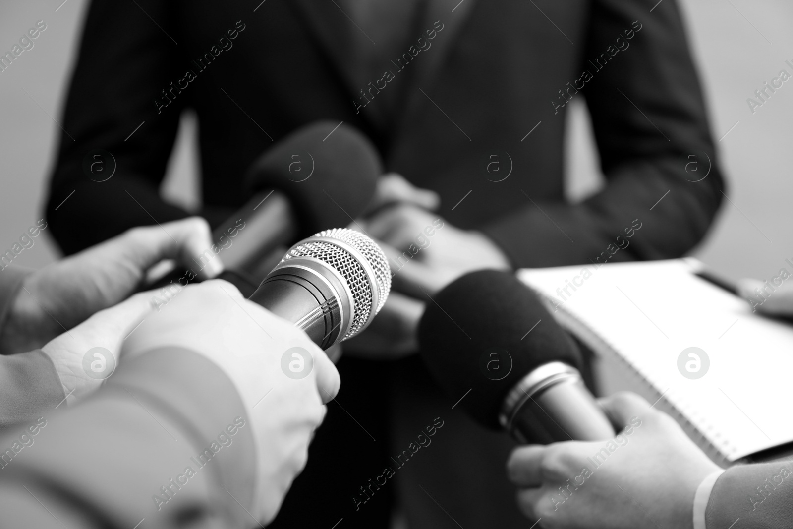 Image of Journalists interviewing businessman, closeup. Toned in black-and-white