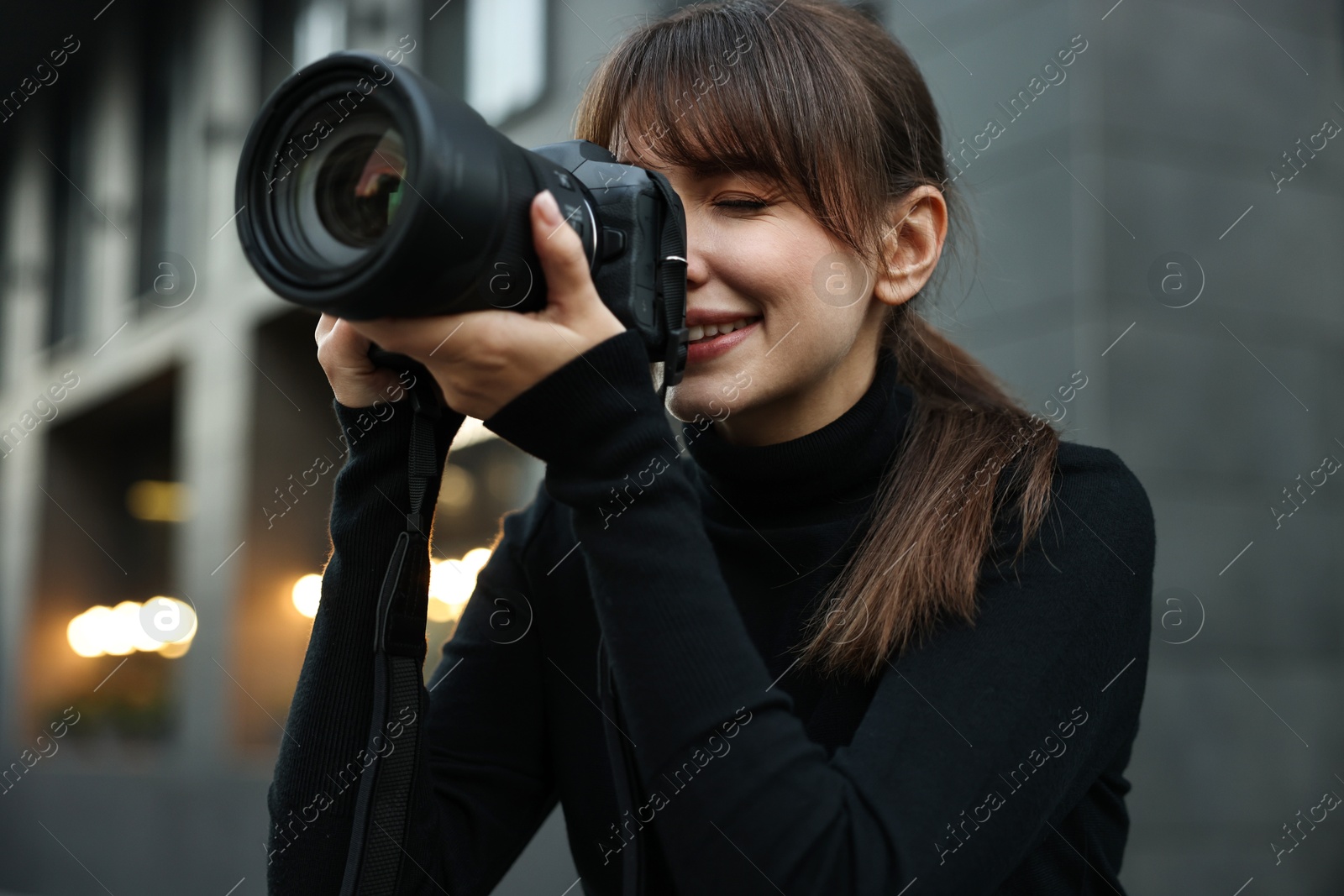 Photo of Professional photographer taking picture with camera outdoors