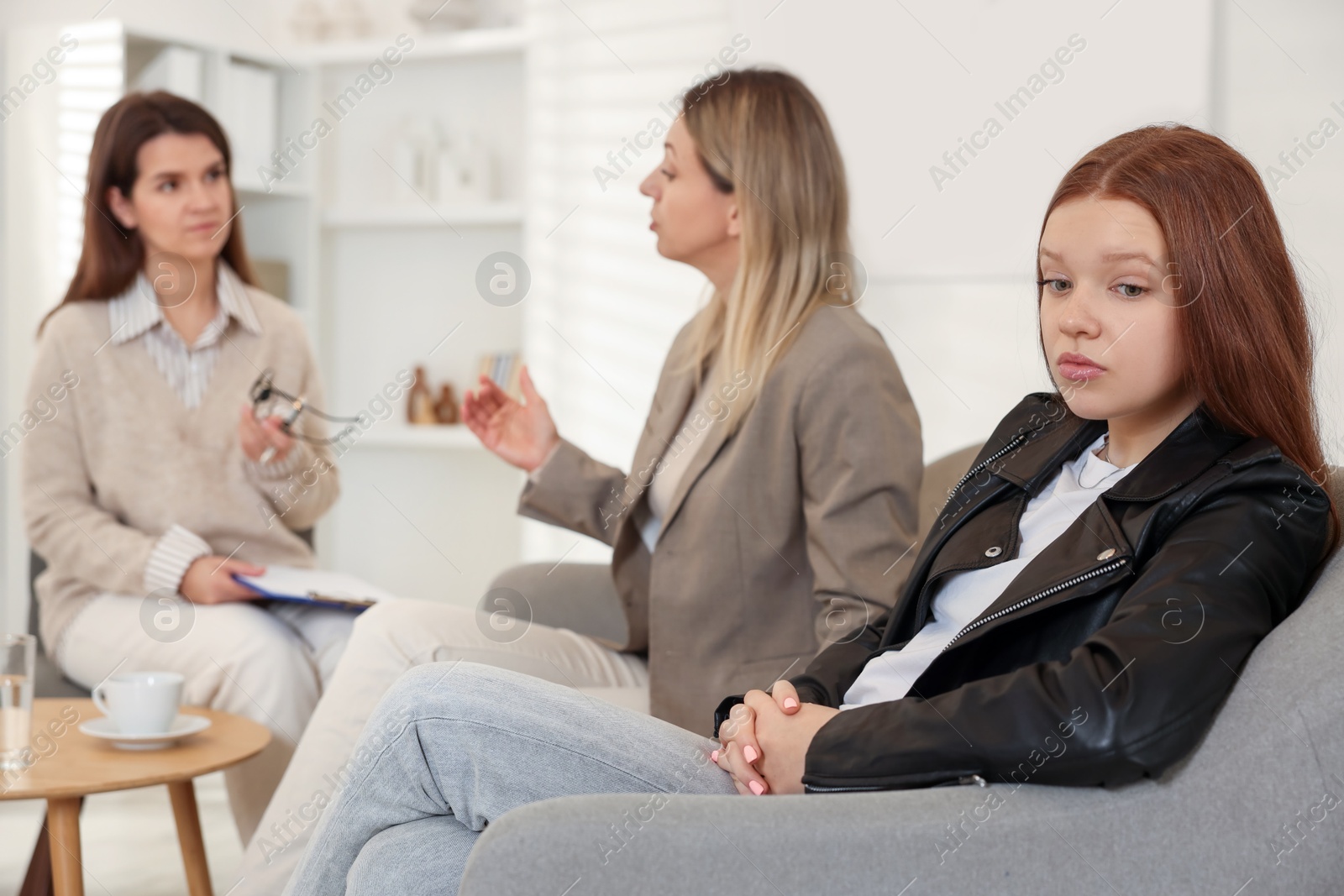 Photo of Difficult teenager. Mother and daughter having consultation with psychologist in office, selective focus