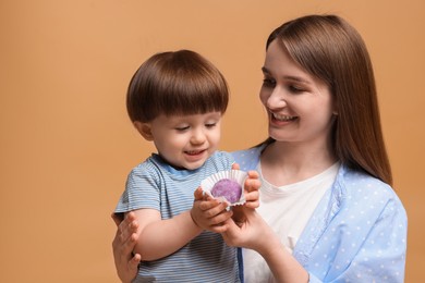 Photo of Mother and baby eating tasty mochi on brown background