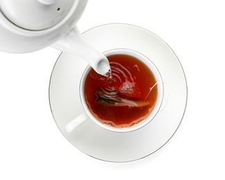 Photo of Pouring hot water into cup with tea bag on white background, top view