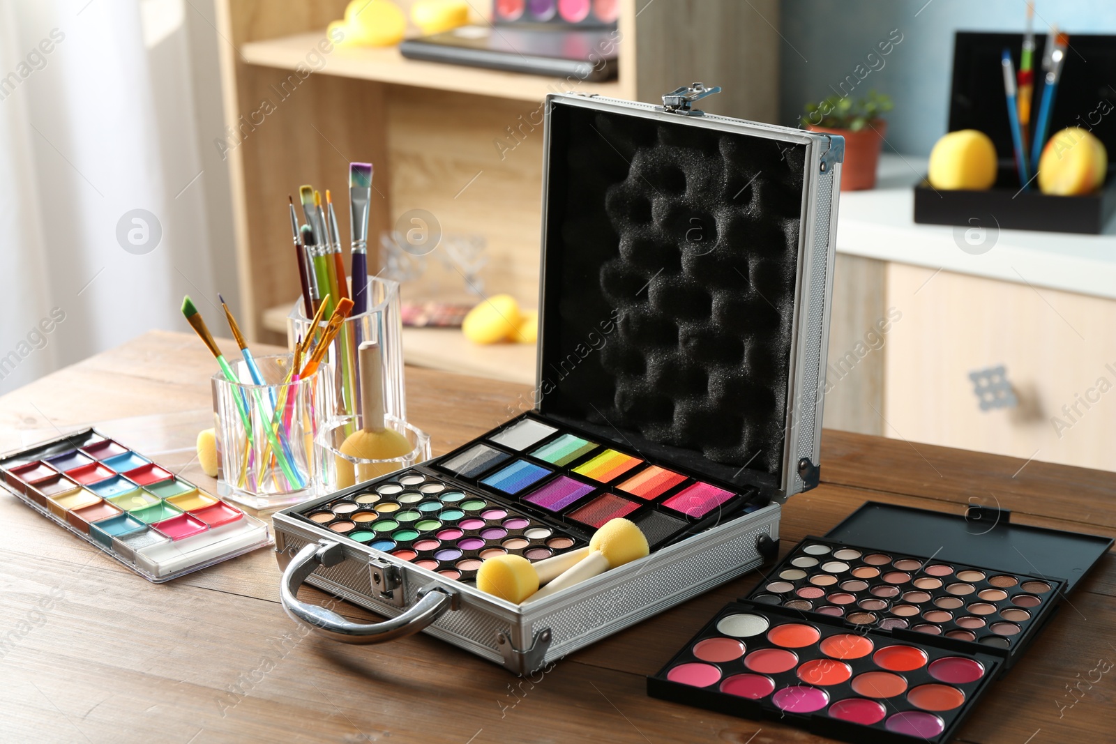 Photo of Face paints and tools on wooden table indoors