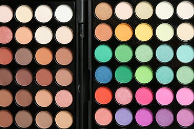 Photo of Palettes with beautiful eyeshadows as background, top view