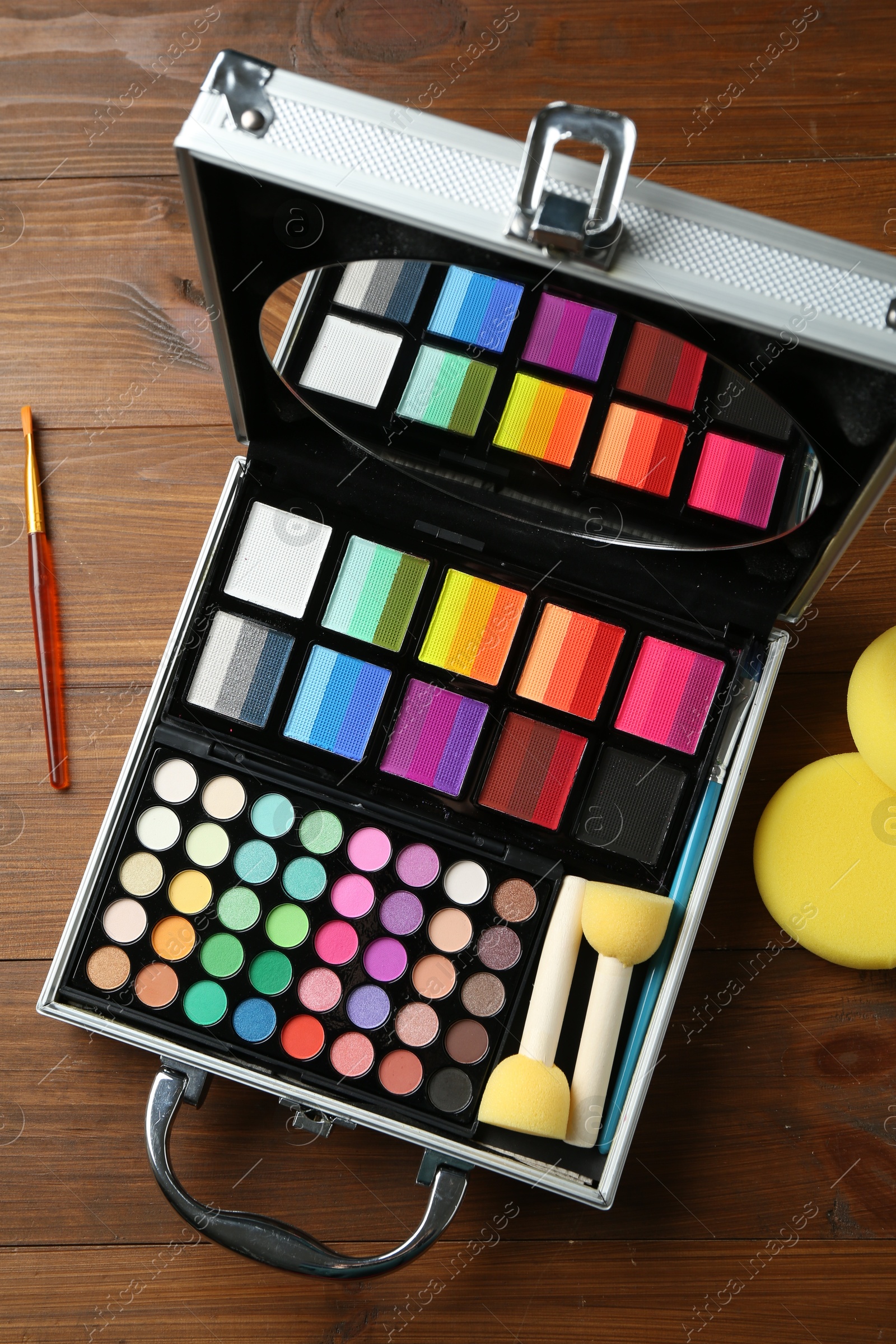 Photo of Face paints and tools on wooden background, top view