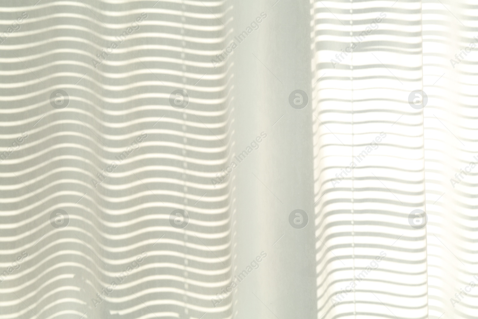 Photo of Beautiful white curtain on window indoors, closeup