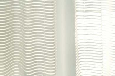 Photo of Beautiful white curtain on window indoors, closeup