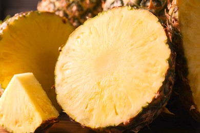 Photo of Slices of ripe pineapple on table, closeup