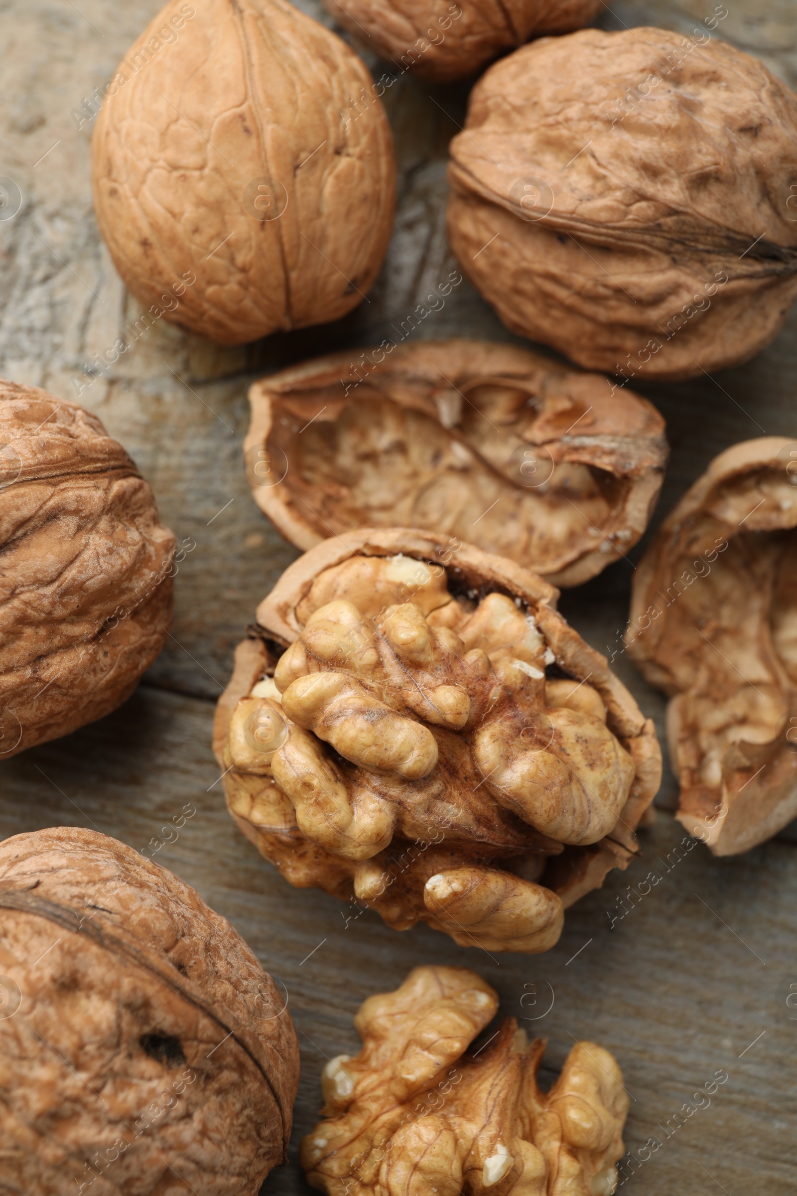 Photo of Fresh walnuts on wooden table, flat lay