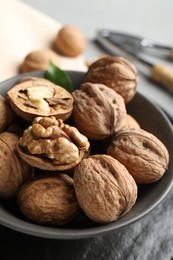 Photo of Fresh walnuts in bowl on table, closeup