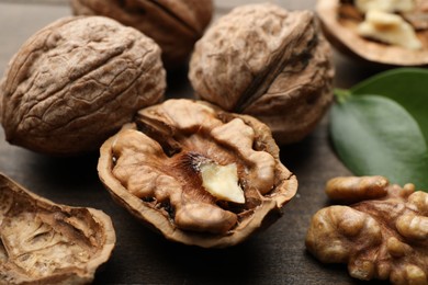 Fresh walnuts with shells on table, closeup