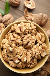 Photo of Peeled walnuts in bowl on table, top view