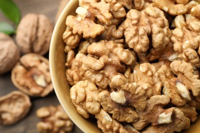 Photo of Peeled walnuts in bowl on table, top view