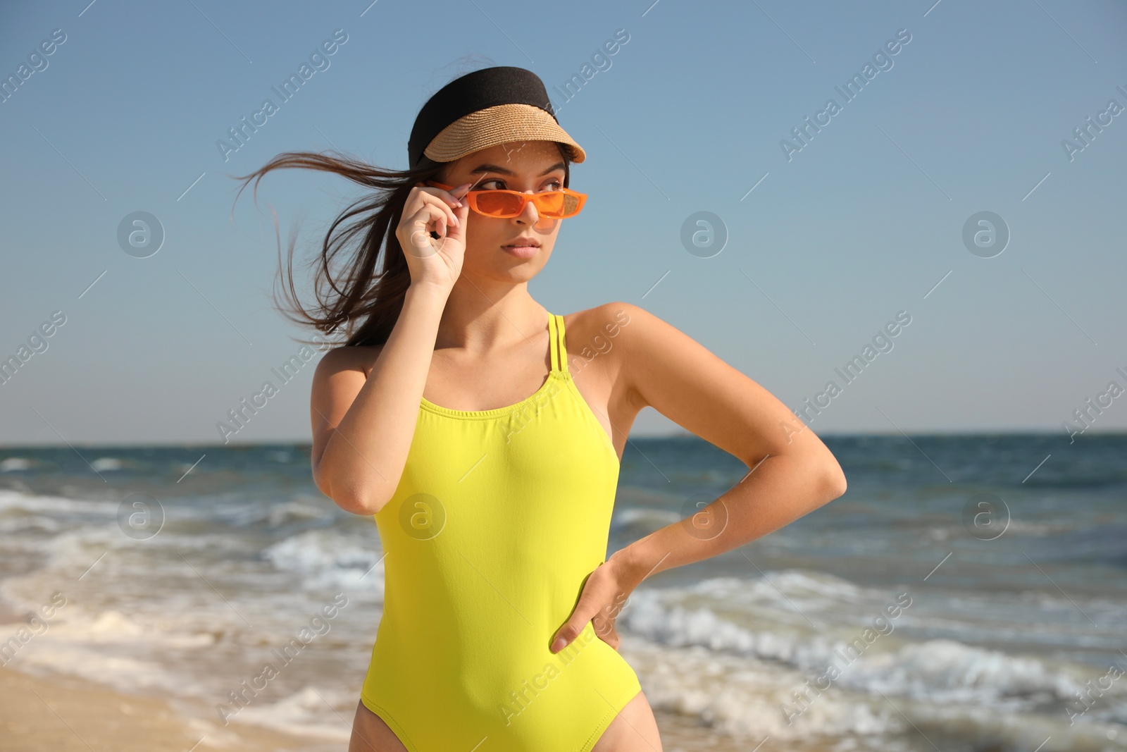 Photo of Beautiful young woman with attractive body on beach