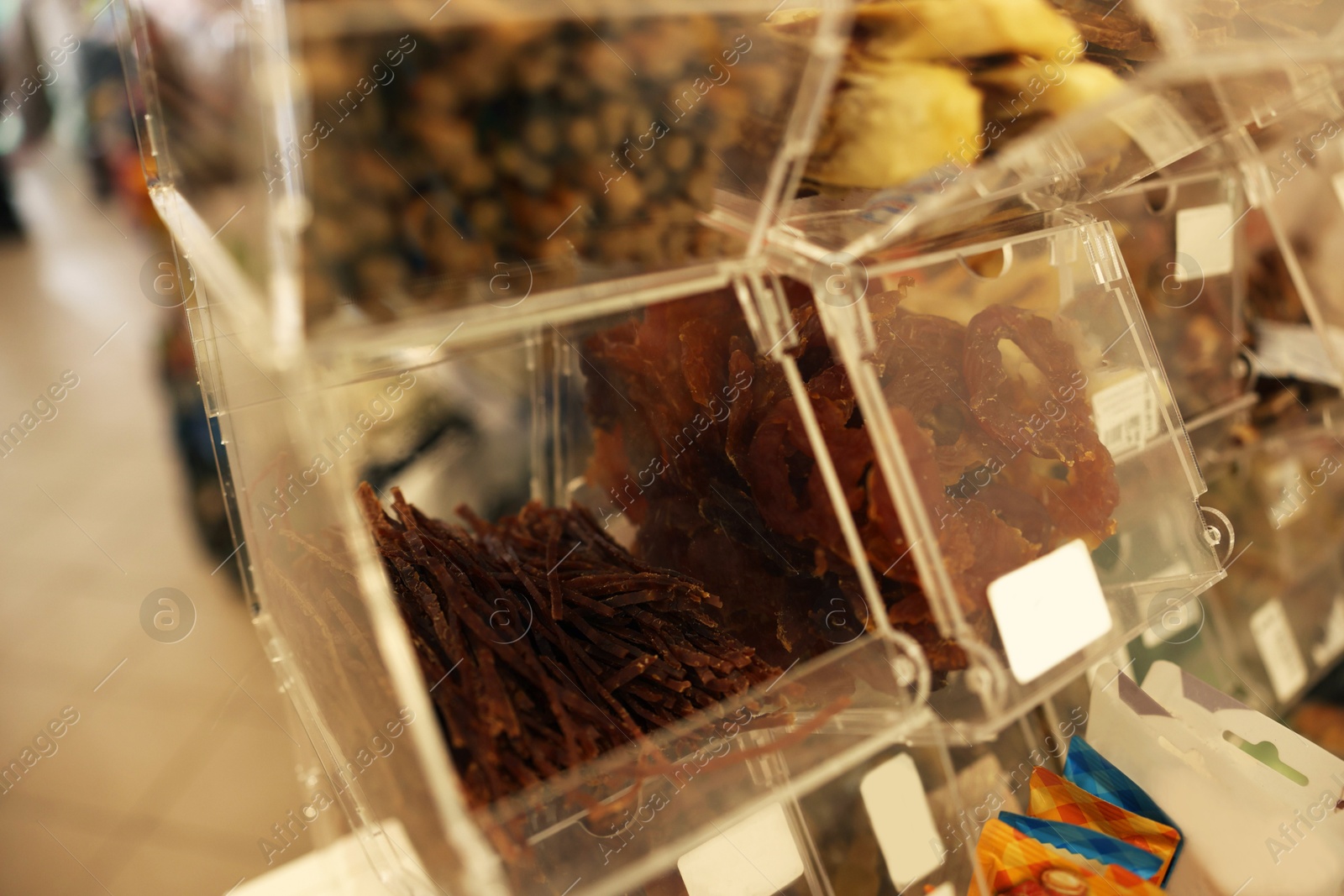 Photo of Display with treats in pet shop, closeup