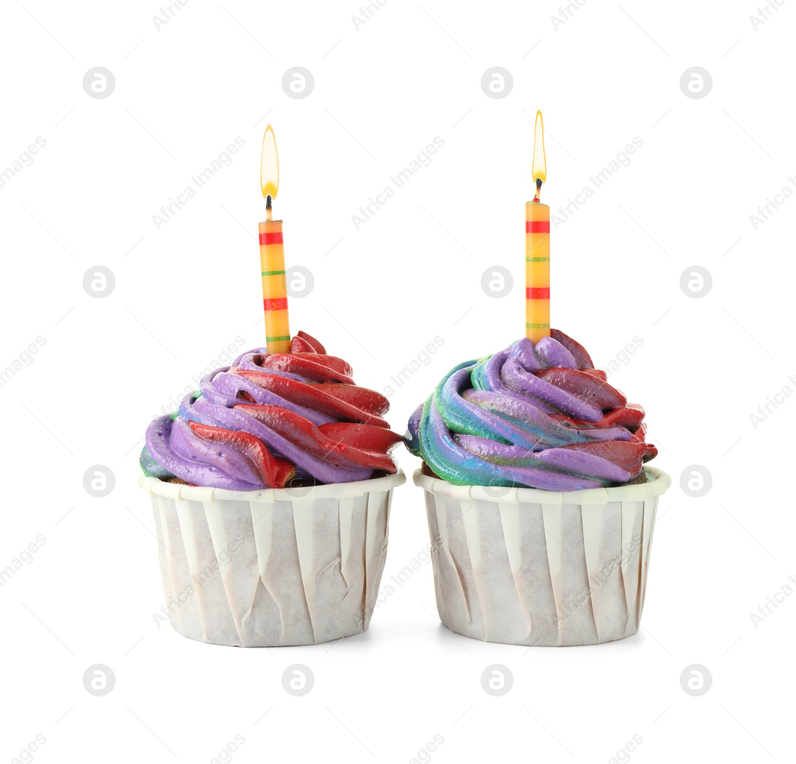 Photo of Delicious cupcakes with colorful cream and candles isolated on white