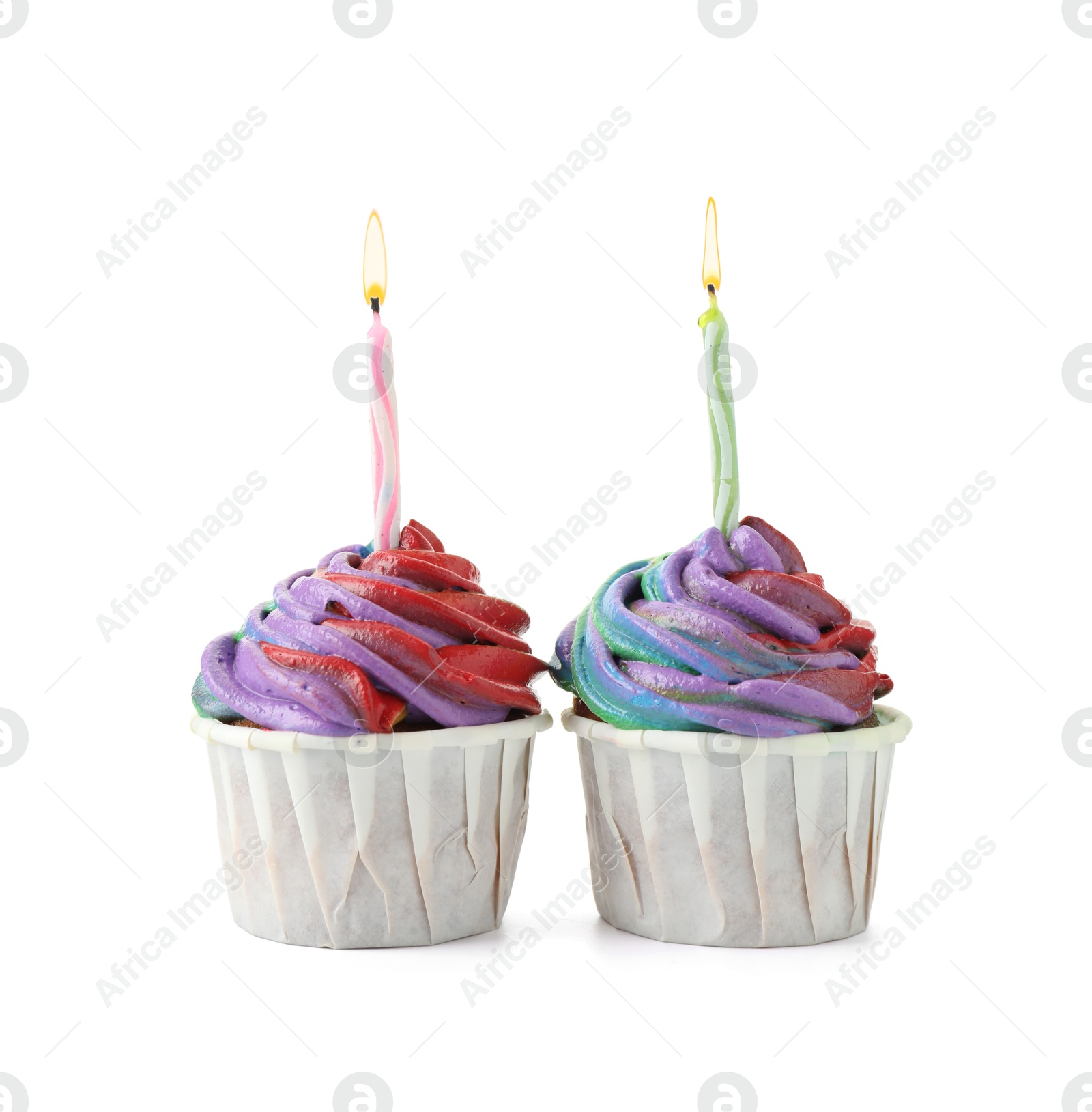 Photo of Delicious cupcakes with colorful cream and candles isolated on white