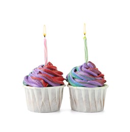 Photo of Delicious cupcakes with colorful cream and candles isolated on white