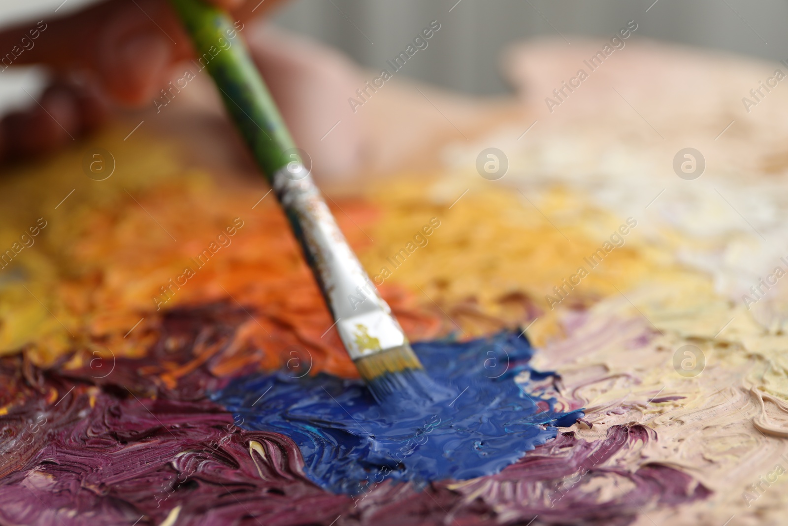 Photo of Painting with palette and paintbrush, closeup view