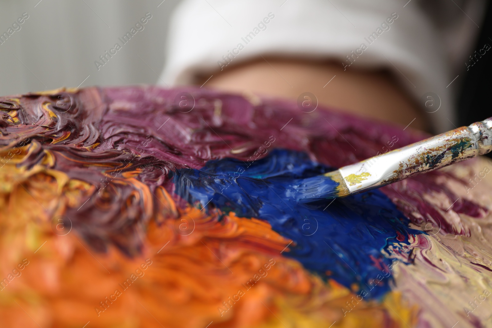 Photo of Painting with palette and paintbrush, closeup view