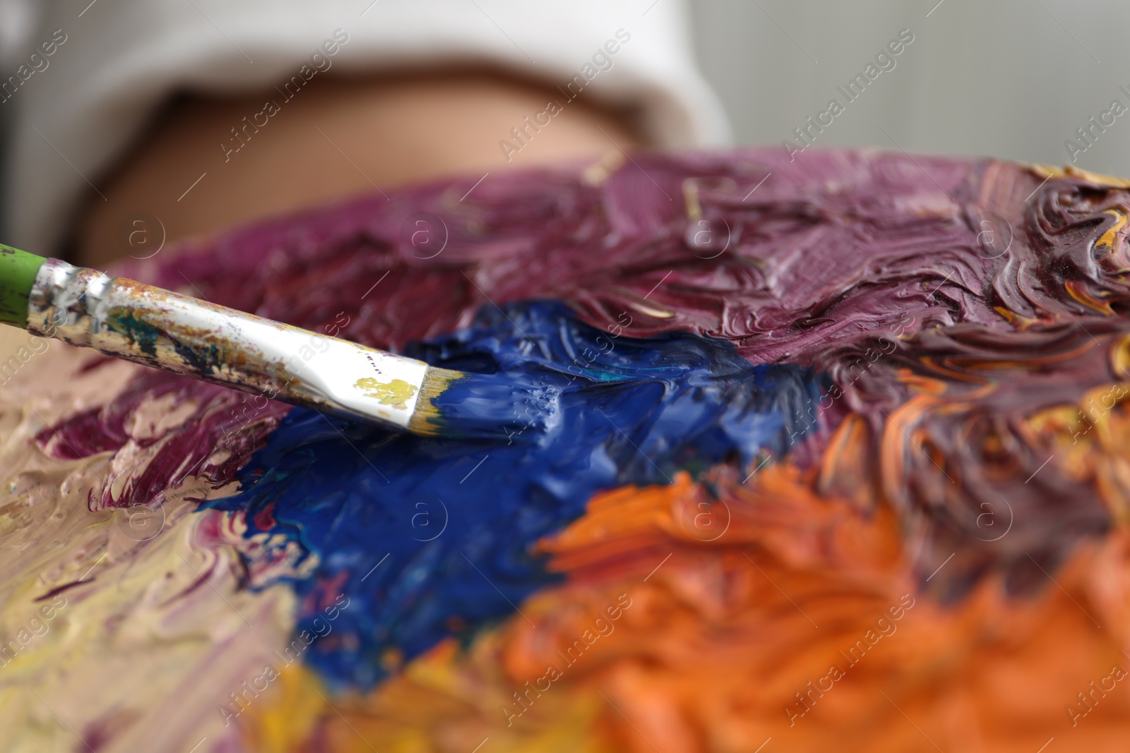 Photo of Painting with palette and paintbrush, closeup view