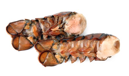 Photo of Two raw lobster tails isolated on white, top view