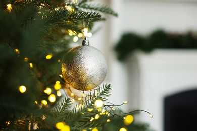 Christmas tree with beautiful lights and bauble indoors, closeup