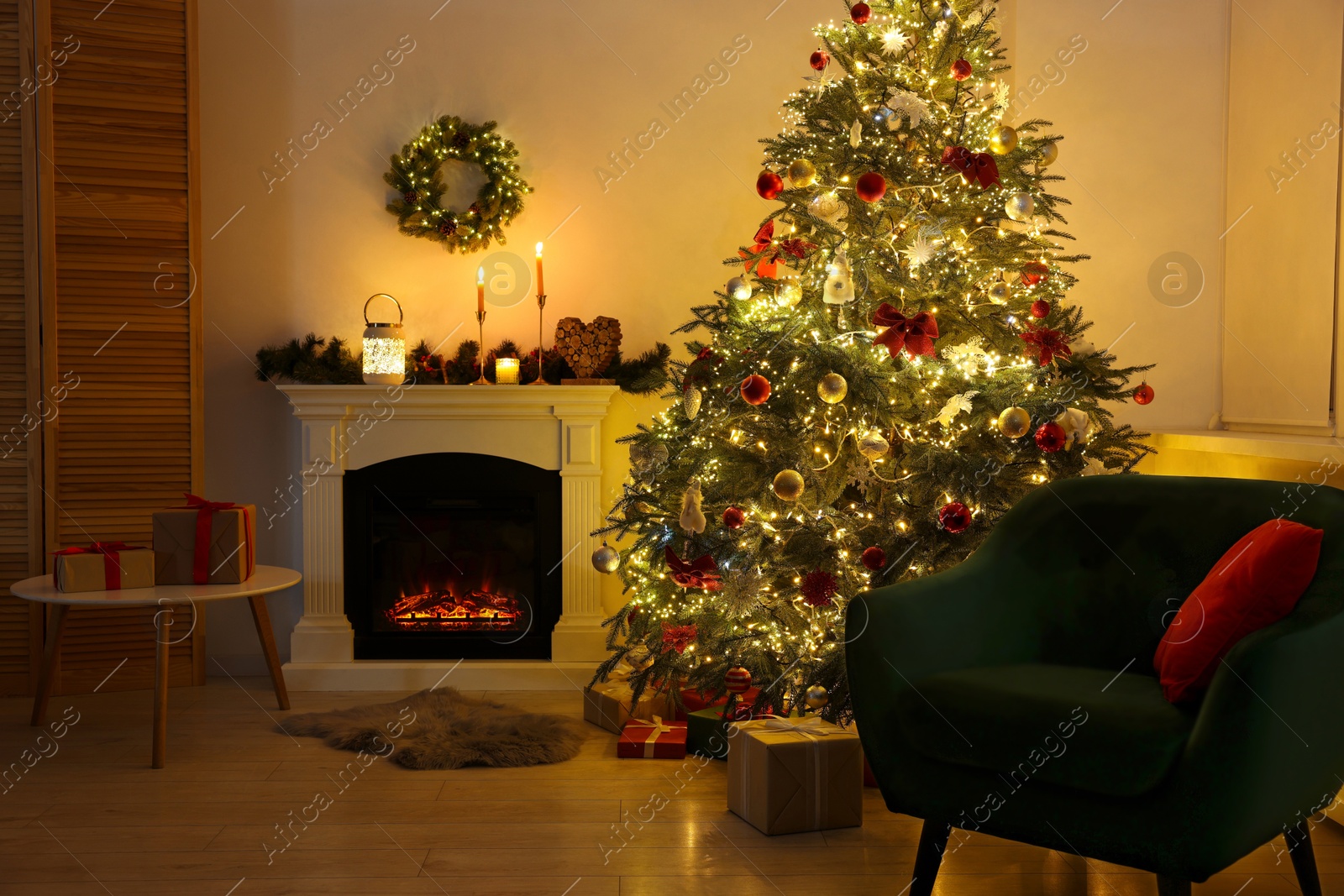 Photo of Decorated Christmas tree near fireplace in room. Festive interior design