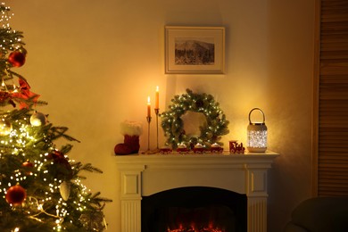 Decorated fireplace and Christmas tree in room. Festive interior design