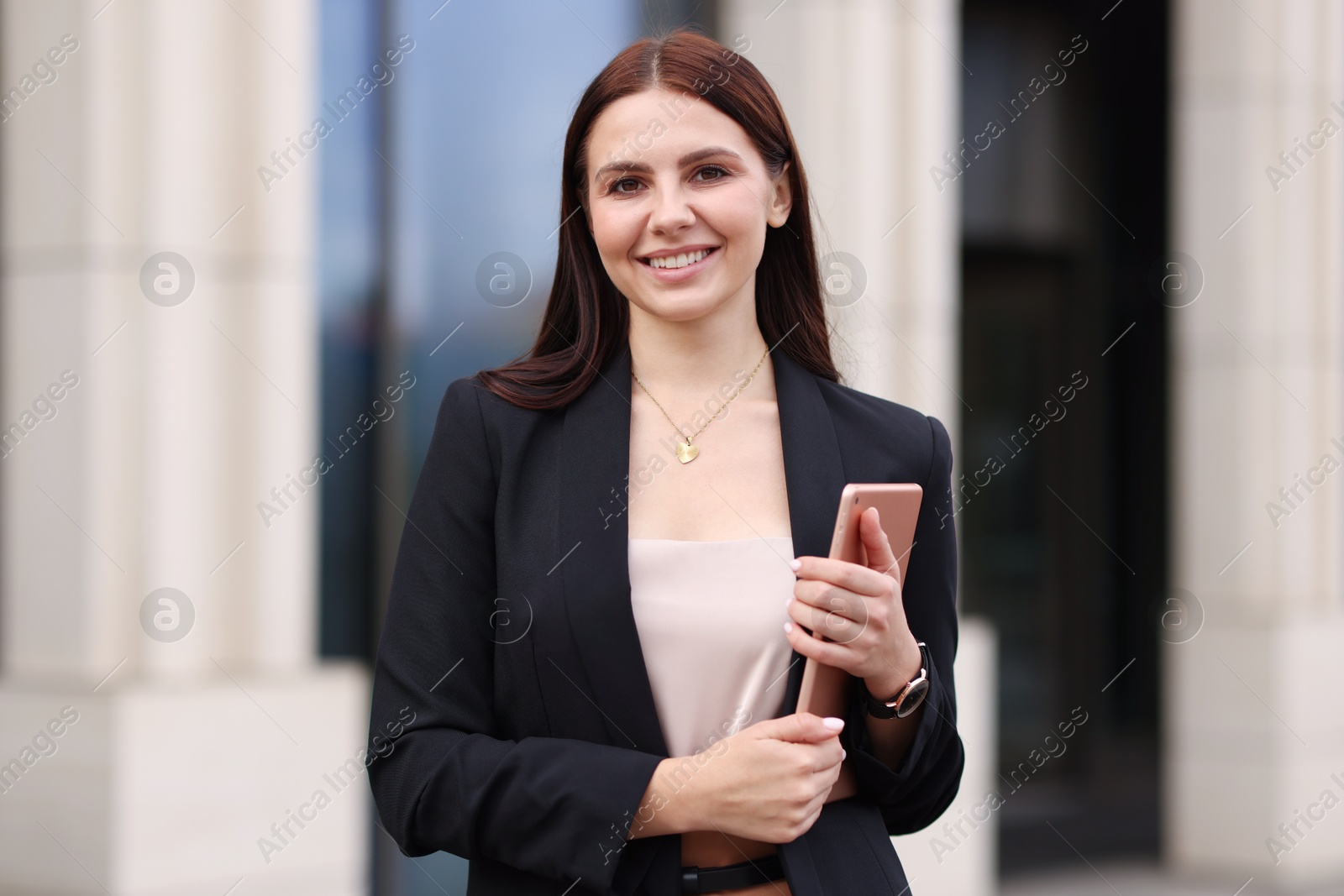 Photo of Woman in stylish formal suit with tablet outdoors