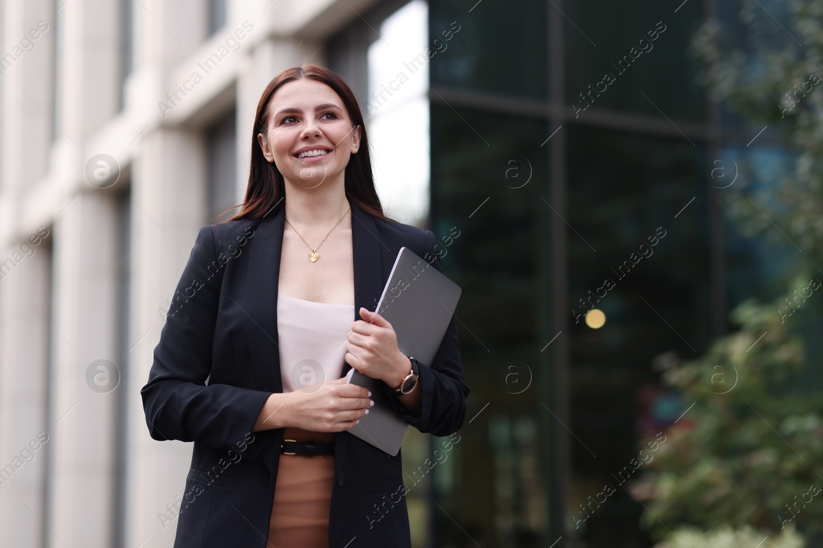 Photo of Woman in stylish formal suit with laptop outdoors. Space for text