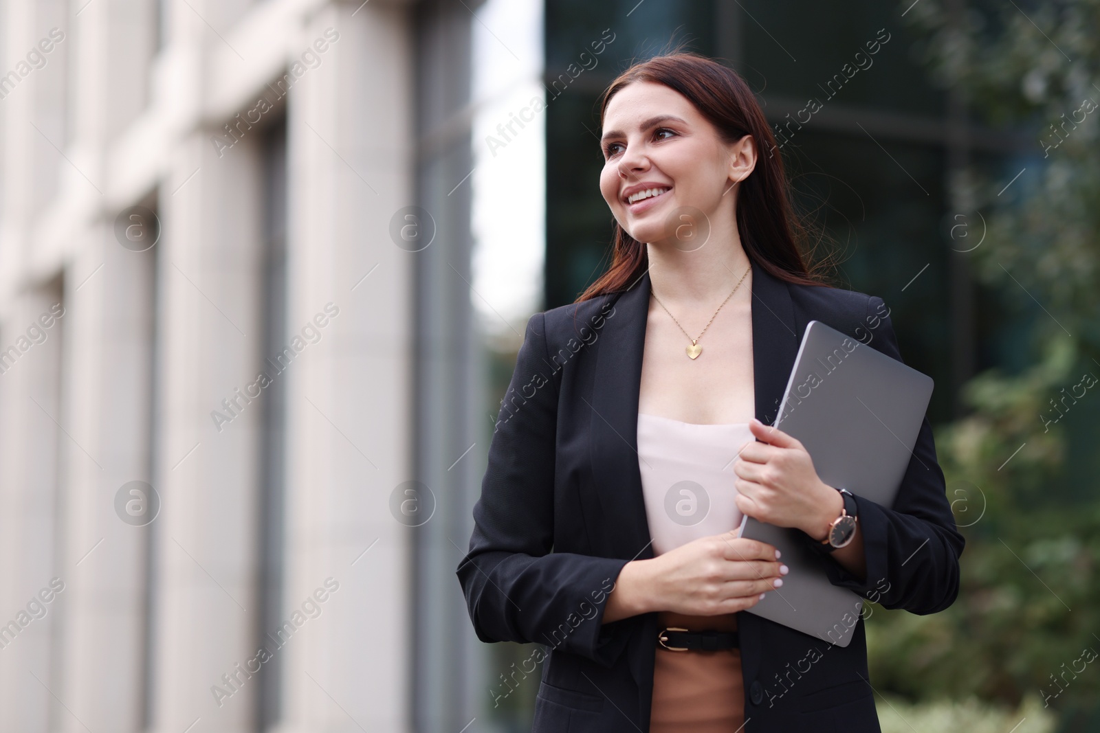 Photo of Woman in stylish formal suit with laptop outdoors. Space for text