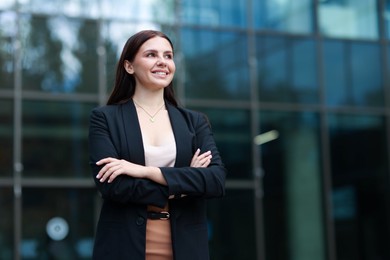 Photo of Beautiful woman in stylish formal suit outdoors. Space for text