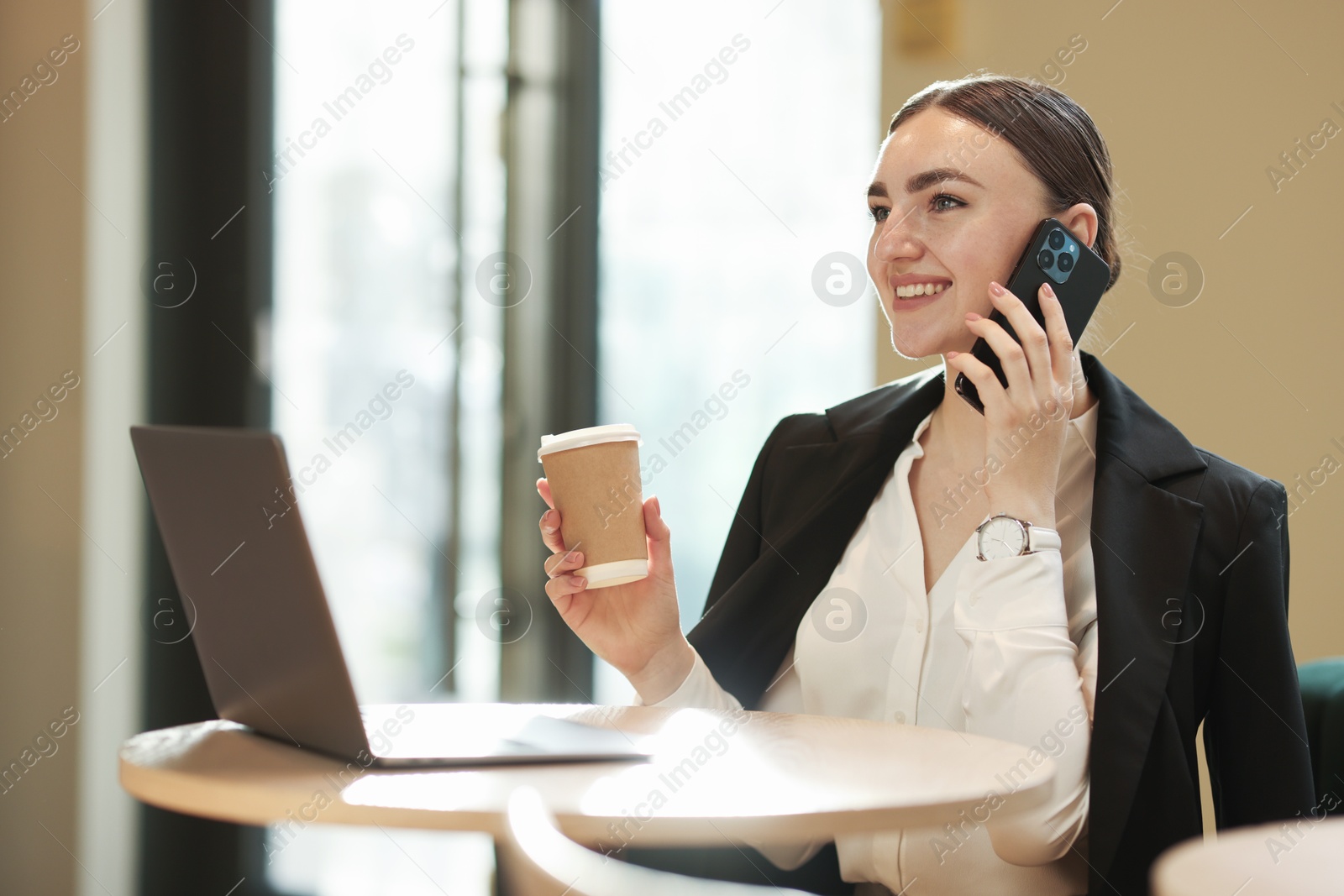 Photo of Woman in stylish formal suit working at table indoors