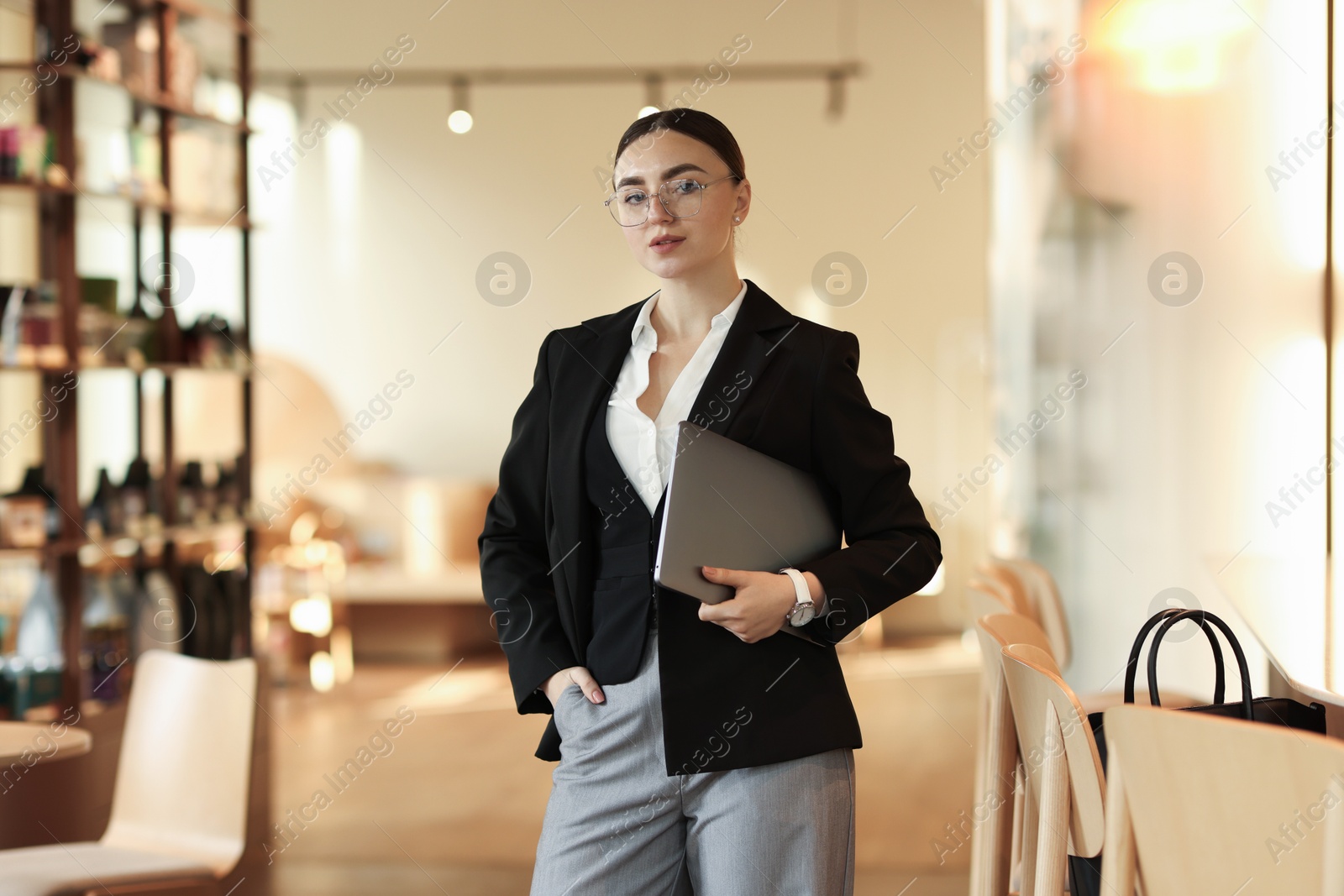 Photo of Woman in stylish formal suit with laptop indoors