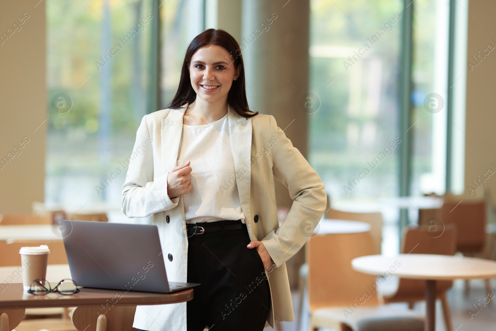 Photo of Woman in stylish formal suit with laptop indoors