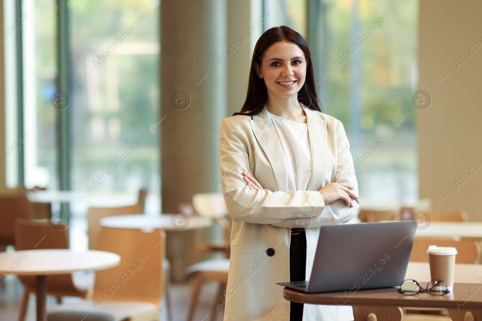 Photo of Woman in stylish formal suit with laptop indoors. Space for text