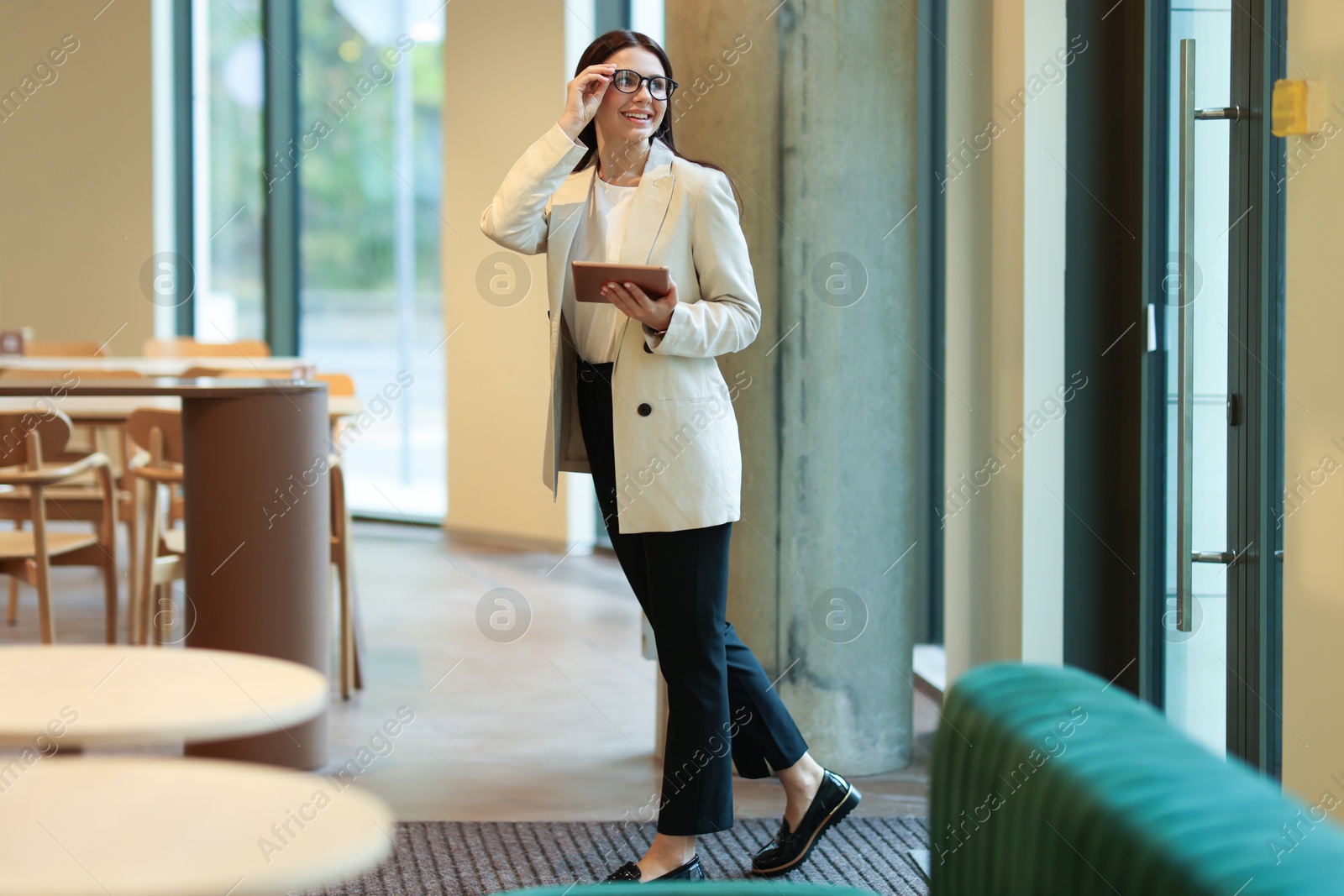 Photo of Woman in stylish formal suit with tablet indoors