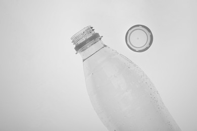 Photo of Empty plastic bottle on white background, top view