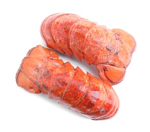 Photo of Tails of boiled lobsters isolated on white, top view