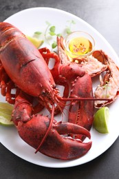 Photo of Delicious boiled lobster served on grey table, closeup