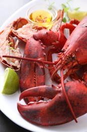 Delicious boiled lobster served on grey table, closeup