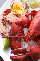 Photo of Delicious boiled lobster served on grey table, closeup