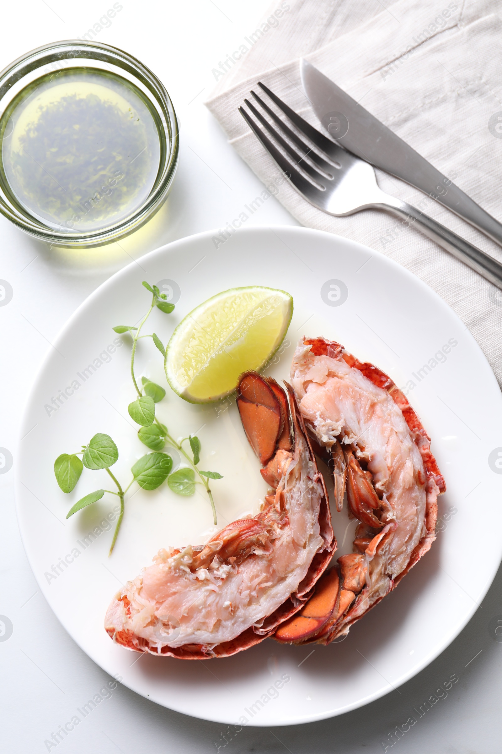 Photo of Delicious boiled lobster served on white table, flat lay